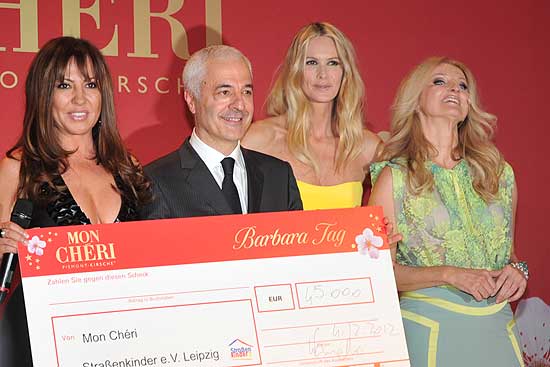 Auf 45.000 € aufgerundet wurde der Scheck, den Carlo Vassallo, Gastgeber & Geschäftsführer von Ferrero Deutschland und das australische Supermodel Elle Macpherson (in gelb) überreichten (©Foto: Martin Schmitz)